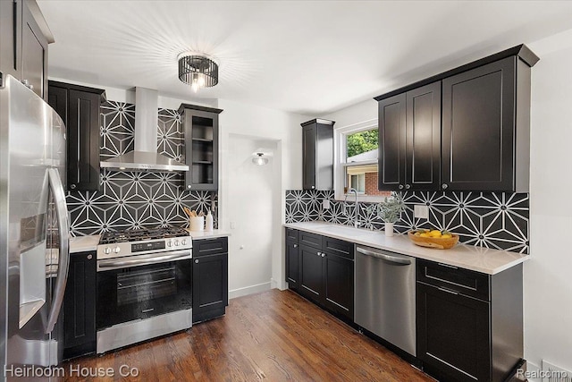 2718 Hubbard St, Dearborn, MI 48124 - kitchen with appliances with stainless steel finishes, island exhaust hood, backsplash, light countertops, and dark cabinets