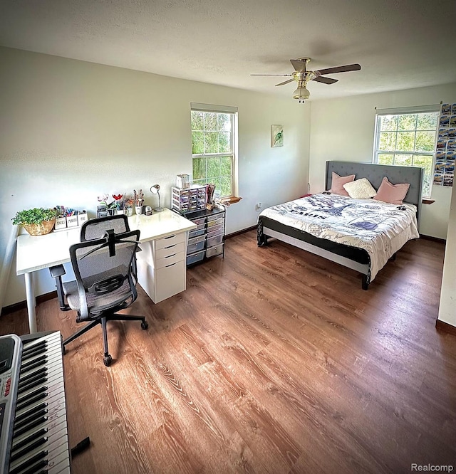 4502 E Wilkinson Rd, Owosso, MI 48867 - bedroom featuring wood finished floors and a desk
