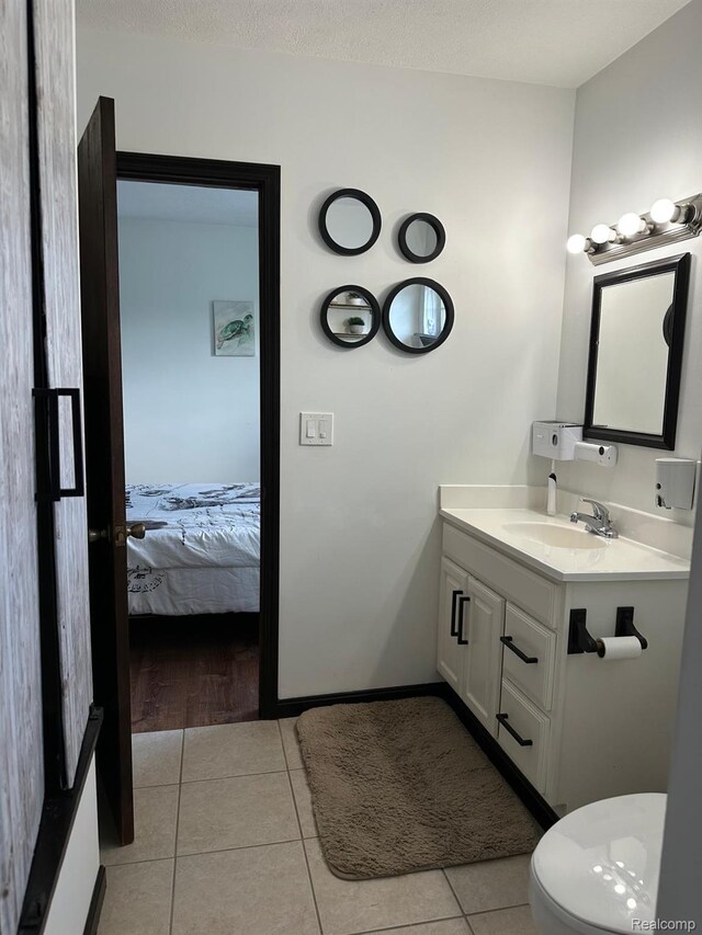 4502 E Wilkinson Rd, Owosso, MI 48867 - bathroom with vanity, tile patterned flooring, and connected bathroom