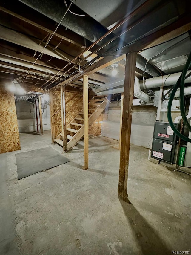 4502 E Wilkinson Rd, Owosso, MI 48867 - unfinished basement featuring stairs and heating unit