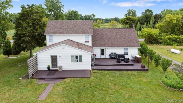 4502 E Wilkinson Rd, Owosso, MI 48867 - rear view of property featuring a yard and a deck