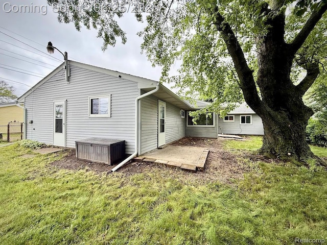2526 Genes Dr, West Bloomfield, MI 48326 - rear view of property with a lawn and a patio