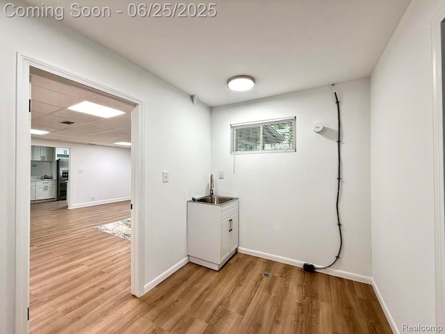2526 Genes Dr, West Bloomfield, MI 48326 - laundry room featuring light wood-style flooring and cabinet space