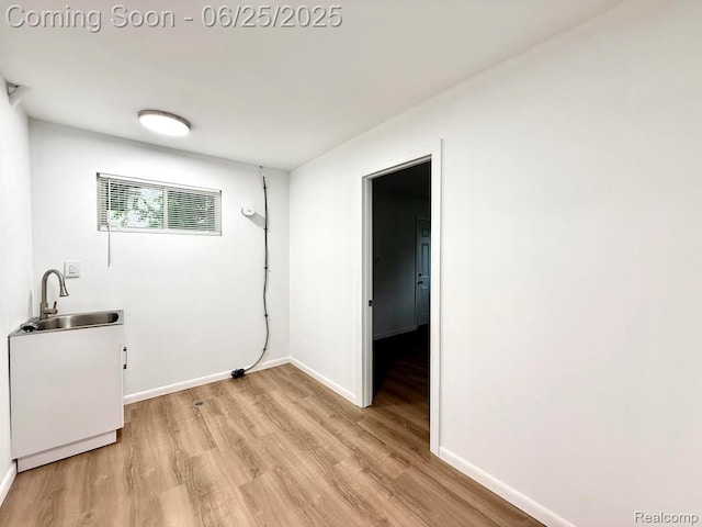 2526 Genes Dr, West Bloomfield, MI 48326 - laundry room featuring a sink and light wood-style floors