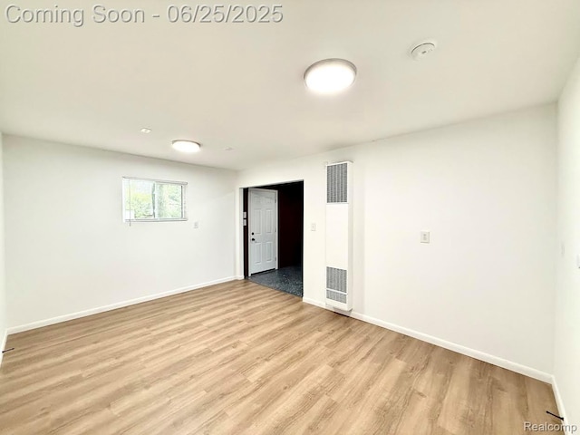 2526 Genes Dr, West Bloomfield, MI 48326 - empty room featuring a heating unit, light wood-style floors, and a smoke detector