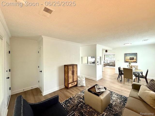 2526 Genes Dr, West Bloomfield, MI 48326 - living area featuring a textured ceiling, wood finished floors, and ornamental molding