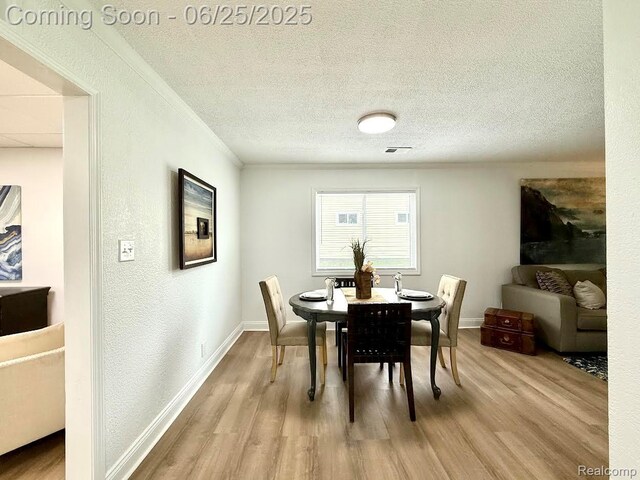 2526 Genes Dr, West Bloomfield, MI 48326 - dining room with wood finished floors, crown molding, and a textured ceiling