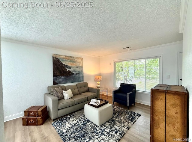 2526 Genes Dr, West Bloomfield, MI 48326 - living area featuring a textured ceiling, crown molding, and wood finished floors