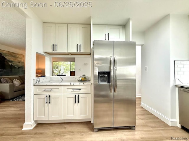 2526 Genes Dr, West Bloomfield, MI 48326 - kitchen featuring appliances with stainless steel finishes, light wood-style floors, white cabinets, and light stone countertops