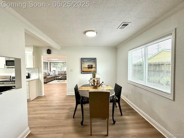 2526 Genes Dr, West Bloomfield, MI 48326 - dining area with crown molding, wood finished floors, and a textured ceiling