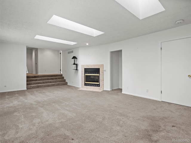 5620 Eastman Blvd, West Bloomfield, MI 48323 - unfurnished living room featuring a skylight, a high end fireplace, stairs, carpet flooring, and recessed lighting