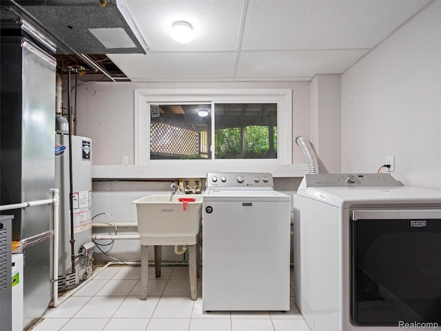 5620 Eastman Blvd, West Bloomfield, MI 48323 - laundry area with separate washer and dryer, gas water heater, and light tile patterned floors
