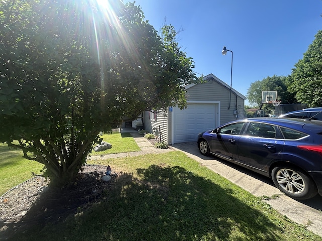 6673 W 64th St, Fremont, MI 49412 - view of home's exterior with a garage, a lawn, concrete driveway, and an outbuilding