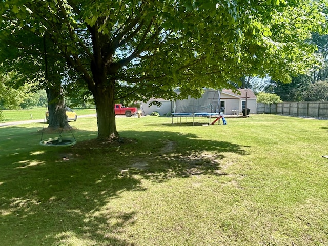 6673 W 64th St, Fremont, MI 49412 - fenced yard with a trampoline