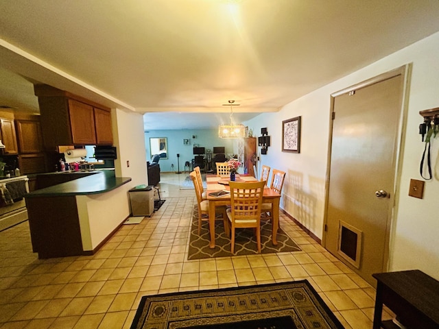 6673 W 64th St, Fremont, MI 49412 - dining space with light tile patterned floors and a chandelier