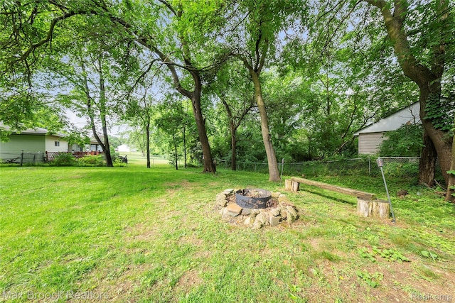 888 Mallock Rd, White Lake, MI 48386 - fenced backyard with an outdoor fire pit
