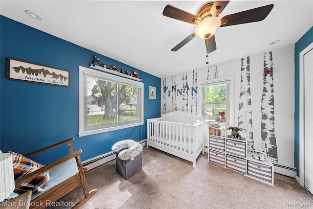 888 Mallock Rd, White Lake, MI 48386 - bedroom featuring carpet flooring, a baseboard heating unit, a nursery area, and a ceiling fan