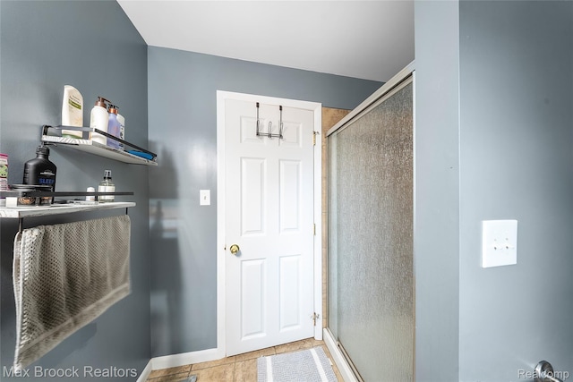 888 Mallock Rd, White Lake, MI 48386 - full bathroom featuring a stall shower and baseboards