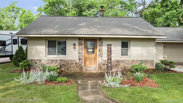 888 Mallock Rd, White Lake, MI 48386 - view of front facade with stone siding, roof with shingles, a chimney, and a front yard