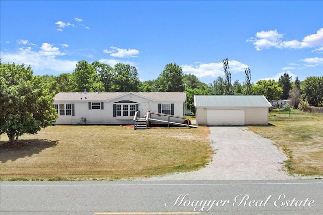 3516 140th Ave, Hamilton, MI 49419 - view of front of property with a front yard, an outbuilding, a garage, and view of wooded area