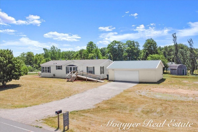3516 140th Ave, Hamilton, MI 49419 - manufactured / mobile home with an outbuilding, a front lawn, and a garage