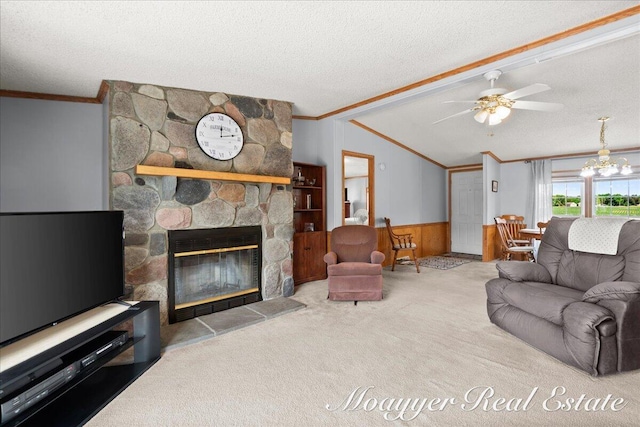 3516 140th Ave, Hamilton, MI 49419 - carpeted living area featuring crown molding, a wainscoted wall, a textured ceiling, a fireplace, and a ceiling fan
