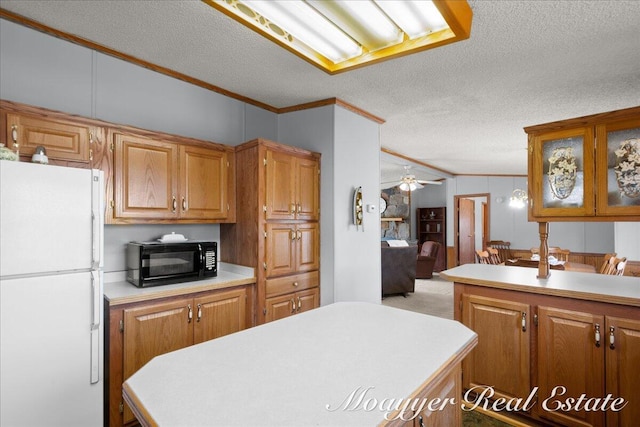 3516 140th Ave, Hamilton, MI 49419 - kitchen with freestanding refrigerator, black microwave, ornamental molding, light countertops, and a textured ceiling