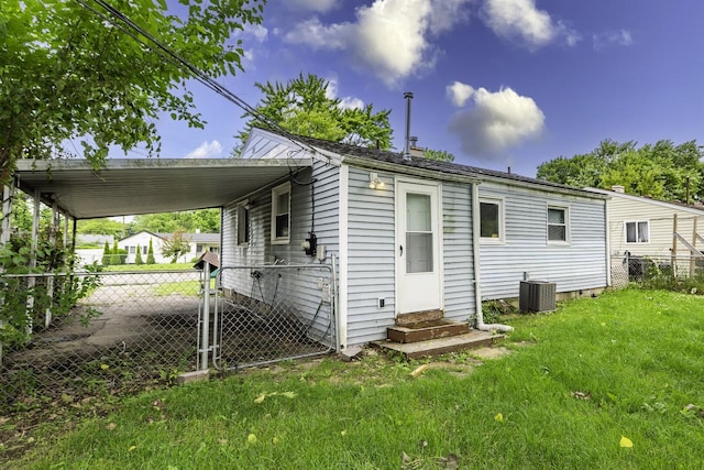 241 Dakota Ave, Ypsilanti, MI 48198 - rear view of house with entry steps and an attached carport