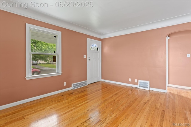 16746 Bramell St, Detroit, MI 48219 - unfurnished room with arched walkways, wood finished floors, and ornamental molding