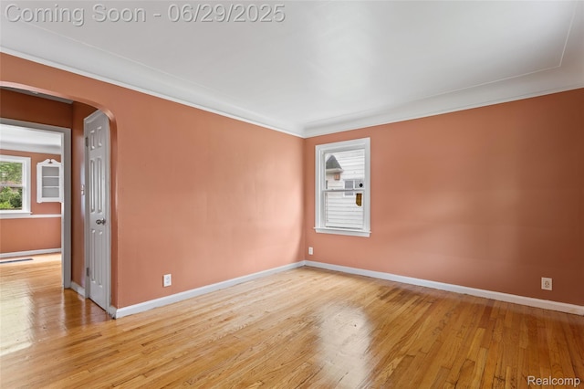 16746 Bramell St, Detroit, MI 48219 - empty room with light wood-style floors, arched walkways, and ornamental molding