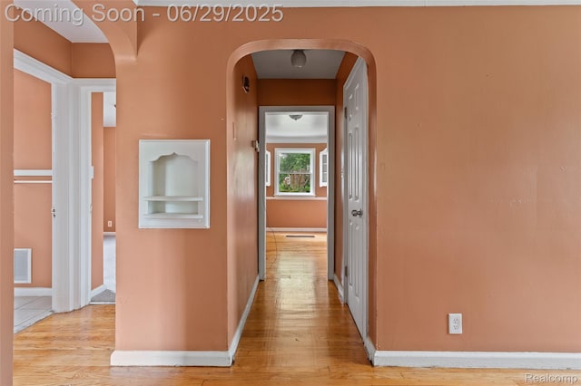16746 Bramell St, Detroit, MI 48219 - hallway with arched walkways and light wood finished floors