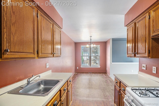 35692 Stillmeadow Ln, Shelby Twp, MI 48035 - kitchen with brown cabinets, light countertops, a chandelier, and light wood-style flooring