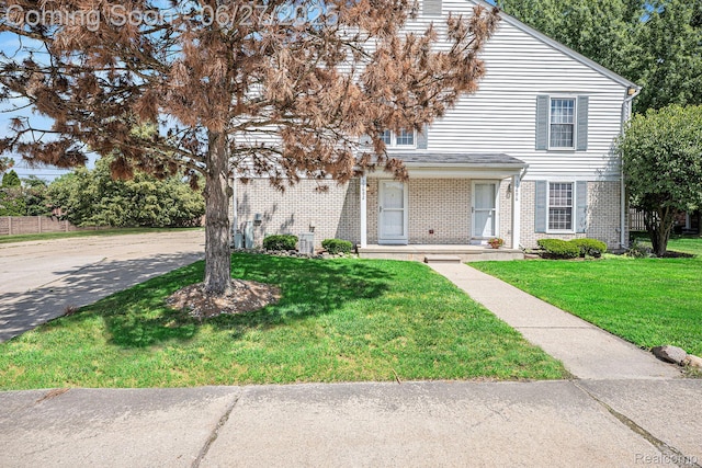 35692 Stillmeadow Ln, Shelby Twp, MI 48035 - traditional-style house featuring brick siding and a front lawn