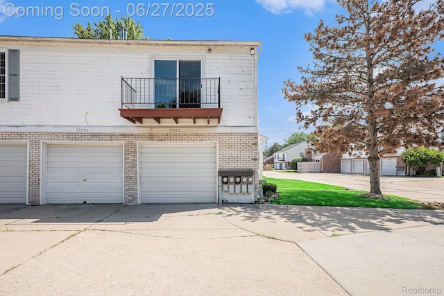35692 Stillmeadow Ln, Shelby Twp, MI 48035 - multi unit property featuring a balcony, concrete driveway, an attached garage, and brick siding