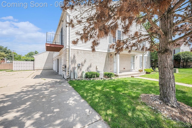 35692 Stillmeadow Ln, Shelby Twp, MI 48035 - view of front of property with a balcony, brick siding, a garage, and driveway