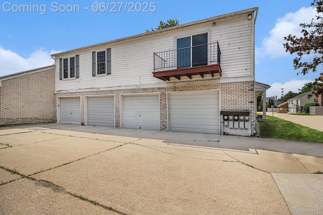 35692 Stillmeadow Ln, Shelby Twp, MI 48035 - view of front of house with a balcony, a garage, brick siding, and driveway