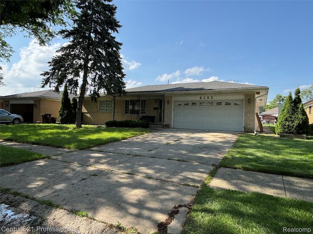 8105 Busch, Center Line, MI 48015 - ranch-style house with an attached garage, concrete driveway, a front yard, and brick siding