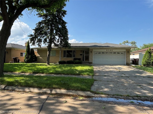8105 Busch, Center Line, MI 48015 - single story home featuring brick siding, a garage, concrete driveway, and a front lawn