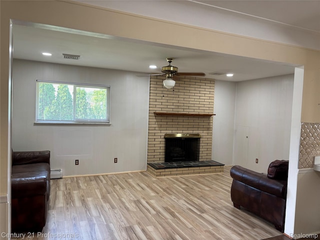 8105 Busch, Center Line, MI 48015 - living room featuring a baseboard radiator, wood finished floors, a ceiling fan, and a fireplace