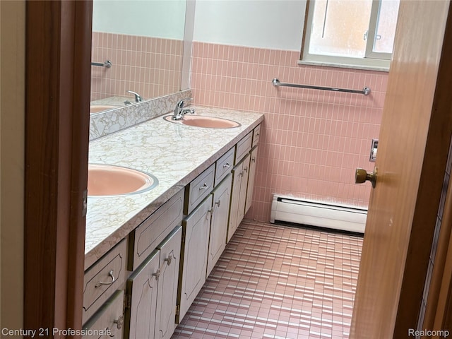 8105 Busch, Center Line, MI 48015 - full bath featuring a baseboard radiator, tile walls, double vanity, tile patterned floors, and a wainscoted wall