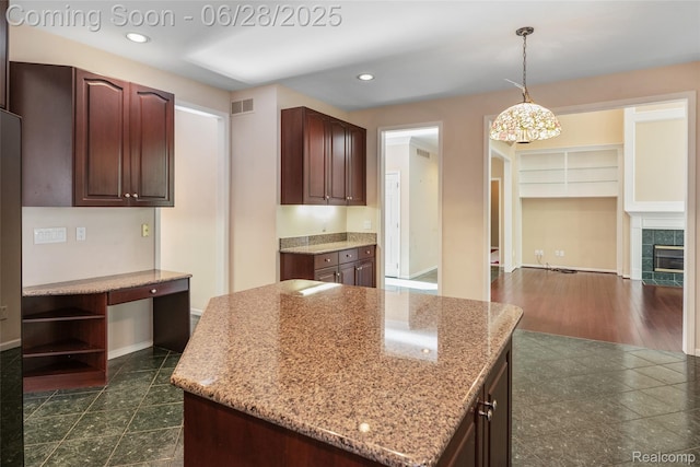 17601 Rolling Woods Cir, Northville, MI 48168 - kitchen with light stone countertops, recessed lighting, hanging light fixtures, a center island, and open shelves