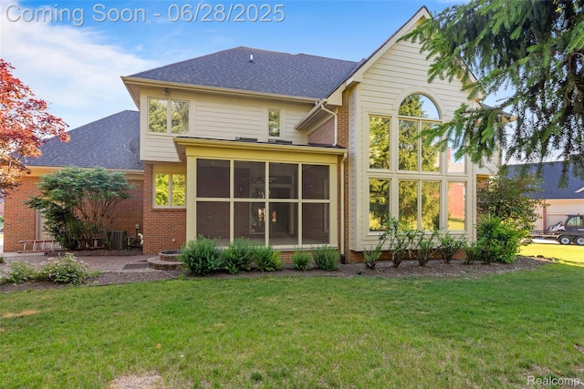 17601 Rolling Woods Cir, Northville, MI 48168 - rear view of house featuring a yard, a sunroom, a shingled roof, and brick siding