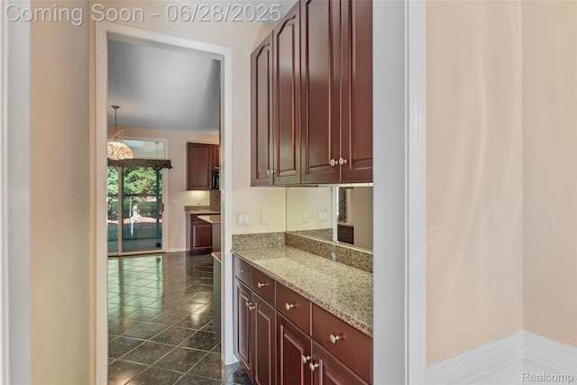 17601 Rolling Woods Cir, Northville, MI 48168 - kitchen featuring light stone counters and baseboards
