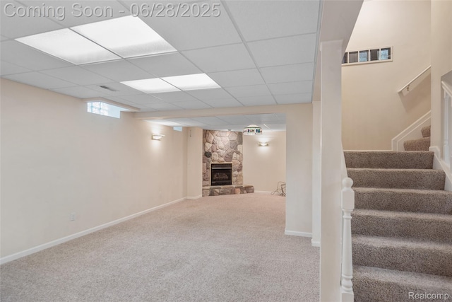 17601 Rolling Woods Cir, Northville, MI 48168 - below grade area with stairs, carpet floors, and a stone fireplace