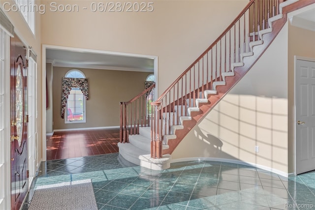 17601 Rolling Woods Cir, Northville, MI 48168 - entryway with ornamental molding, stairs, and a towering ceiling