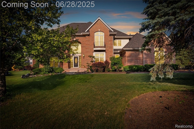 17601 Rolling Woods Cir, Northville, MI 48168 - traditional-style house featuring brick siding, a front yard, and a shingled roof
