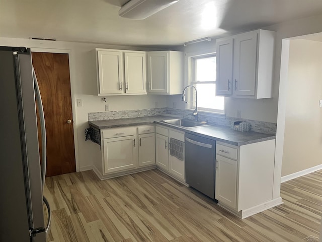 4704 Bishop St, Millington, MI 48746 - kitchen with appliances with stainless steel finishes, light wood-style flooring, white cabinetry, and light countertops