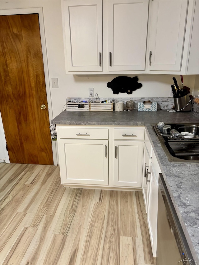 4704 Bishop St, Millington, MI 48746 - kitchen with dishwasher, light wood-style flooring, white cabinets, and dark countertops