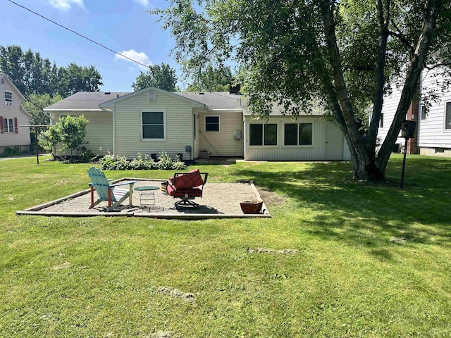 4704 Bishop St, Millington, MI 48746 - rear view of property with an outdoor fire pit, a patio, and a yard