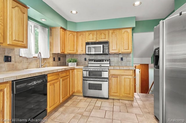274 Beaver St, Brighton, MI 48116 - kitchen featuring stainless steel appliances, tile counters, light brown cabinets, tasteful backsplash, and light stone finish flooring